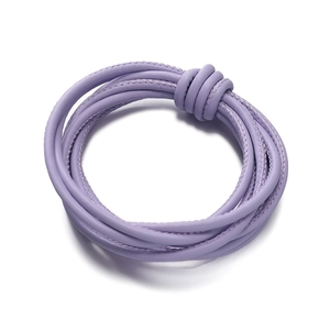 Close-up of light purple braided PU leather cord with fine stitching and a center knot