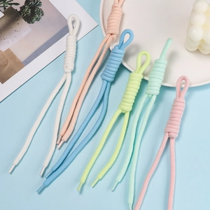 Detail of colorful braided cotton cords for phone charms and bag straps with looped knots