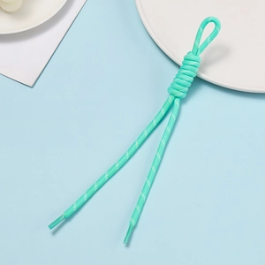 Detail of mint green woven polyester lanyard with a knot and clear sealed rope ends
