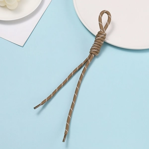 Close-up of brown braided polyester lanyard with white dotted texture and plastic tips