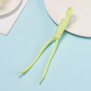 Macro shot of neon green hand-woven cord with clear plastic tips for bags and phones