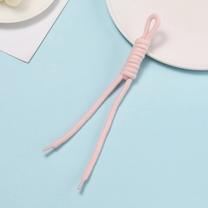 Detail of pink hand-woven rope with a special knotted loop on a soft blue background
