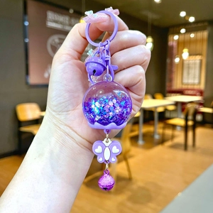Porte-clés bouteille flottante violette avec paillettes étoiles et petites cloches