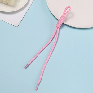 Close-up of pink braided polyester lanyard with handcrafted knot and white dotted texture