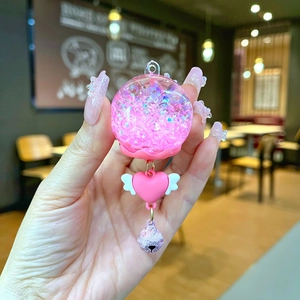 Luminous pink wind chime keychain with drifting glitter ball and heart wing charm