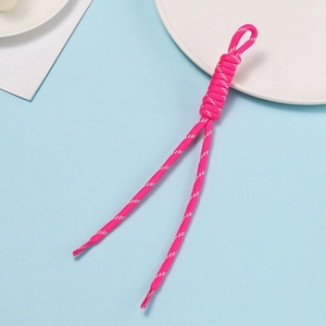 Detailed view of pink woven polyester lanyard with ring clasp on blue background