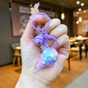 Detailed view of purple ice cream keychain with pastel beads and small bell