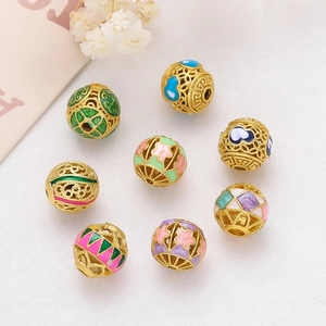 Macro detail of cloisonne enamel beads with gold hollow pattern for jewelry making
