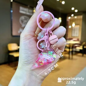 Detailed view of pink ice cream keychain with sequins and bells, 4.7cm x 2.5cm size