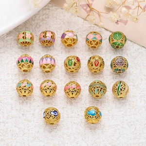 Macro detail of hollow gold-plated cloisonne beads with colorful enamel floral patterns