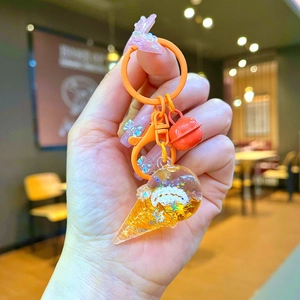 Detailed close-up of an ice cream keychain with glitter liquid and small bell charm