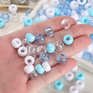 Detail shot of mixed acrylic beads in hand for DIY jewelry making and phone charms