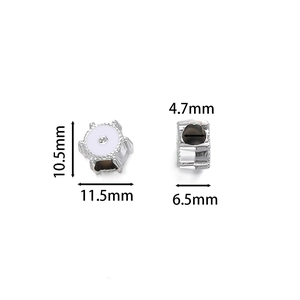 Macro view of gear-shaped silver spacer bead with white enamel and crystal for DIY jewelry