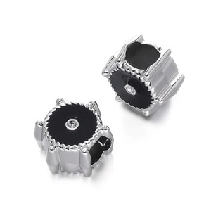 Macro view of gear-shaped silver CCB beads with black enamel center for DIY jewelry