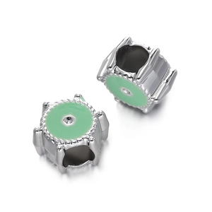 Close-up of silver metal charms with mint green enamel and twisted rope edge detail