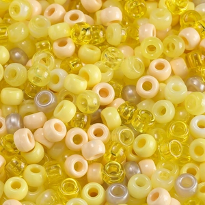 Macro shot of assorted yellow acrylic candy beads with large holes for DIY jewelry
