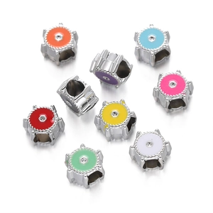 Macro view of multi-color enamel gear beads with central zircon for DIY jewelry bracelets