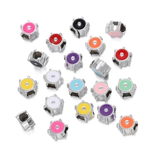 Macro detail of colorful enamel snowflake charms with center crystals for DIY jewelry making