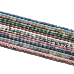 Détail macro de perles tubes 2x4mm en diverses pierres naturelles aux couleurs variées