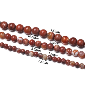 Detailed view of 6.5mm to 10.5mm natural red fire agate beads with 1.5mm drill holes