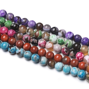 Detailed view of polished 8mm natural stone beads in assorted vibrant agate colors