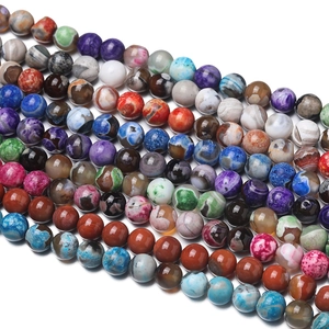 Detail view of multi-color natural agate stone beads with marbled texture and glossy finish