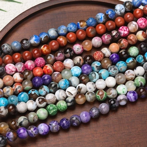 Macro shot of colorful polished agate beads showing natural fire veins on a wooden plate