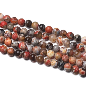 Macro detail of natural red fire agate beads with unique circular patterns and polished finish