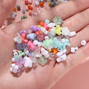 Macro shot of colorful pastel acrylic beads in star and flower shapes for DIY jewelry