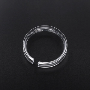Macro view of transparent acrylic C-shaped ring display stand with polished edges