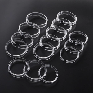 Detailed view of twelve clear acrylic rings for bracelet and jewelry display stand