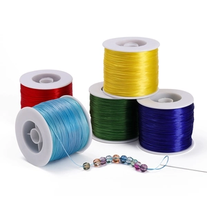 Macro shot of 0.8mm elastic cord spools with crystal beads and needle for DIY jewelry
