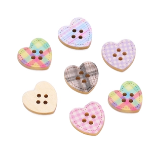Close-up of assorted heart-shaped wooden buttons with colorful patterns and 4 holes