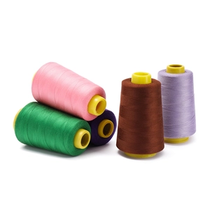 Detail of 402 polyester sewing thread spools in pink green purple and brown colors
