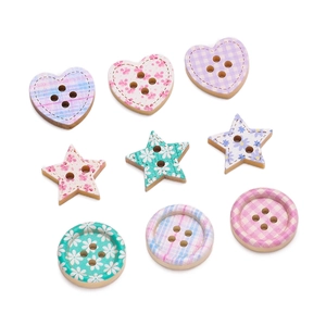 Macro shot of assorted floral and plaid painted wooden buttons in heart and star shapes