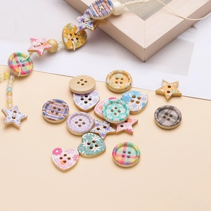 Flat lay of colorful printed wooden buttons in heart and star shapes for DIY crafts