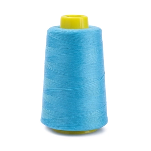 Detailed view of sky blue polyester sewing thread roll on yellow plastic core spool