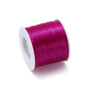 Close-up of 0.8mm rose red elastic TPU beading thread on white spool for DIY jewelry