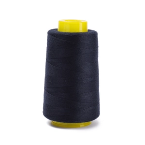 Detailed view of dark navy 402 polyester sewing thread on yellow plastic cone core