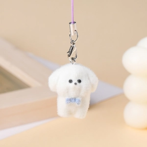 Close-up of cute white flocked puppy pendant with blue bow and silver lobster clasp