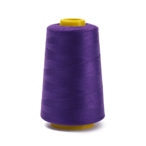 Close-up of deep purple 402 polyester sewing thread on a yellow plastic cone bobbin