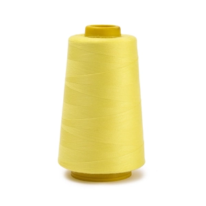 Macro detail of high-quality yellow polyester sewing thread on a large industrial spool