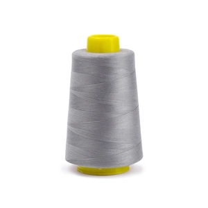 Detail of grey 402 polyester sewing thread wound on yellow cone for sewing machines