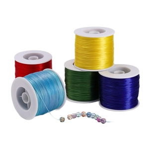 Five rolls of 0.8mm colorful elastic beading thread with crystal glass beads on white background