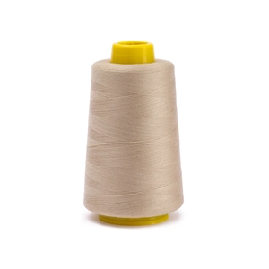 Close-up of beige 402 polyester sewing thread on a yellow cone for garment stitching