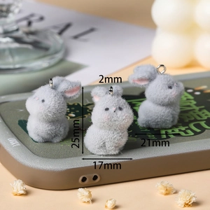 Close-up of cute grey flocked rabbit charms with dimensions of 25mm height for DIY crafts