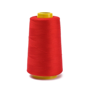 Close-up of industrial red polyester sewing thread on yellow spool for machines