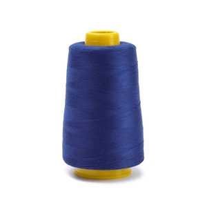 Detail of royal blue 402 polyester sewing thread on yellow plastic core for machines