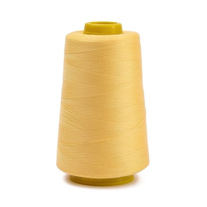 Close-up of light yellow 402 sewing thread on a spool for industrial and DIY projects