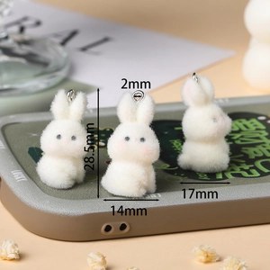 Close-up of 28.5mm white flocked rabbit pendants with silver hooks for DIY crafts